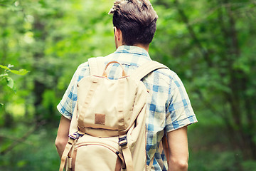 Image showing young man with backpack hiking in woods