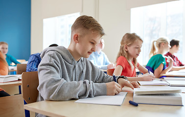 Image showing group of students with books writing school test