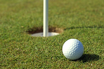 Image showing Golfball in front of the hole