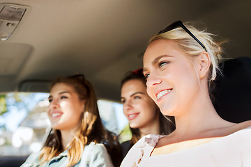 Image showing happy teenage girls or young women driving in car