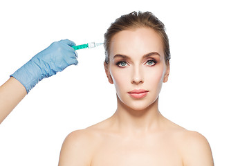 Image showing woman face and hand with syringe making injection