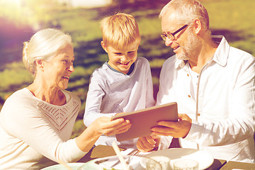 Image showing happy family with tablet pc outdoors