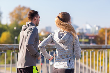 Image showing happy couple running outdoors