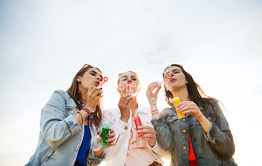 Image showing young women or girls blowing bubbles outdoors