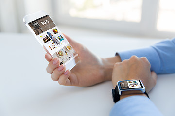 Image showing close up of hands with smart phone and watch