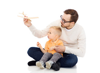 Image showing father and little son playing with toy airplane