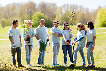 Image showing group of volunteers with trees and rake in park
