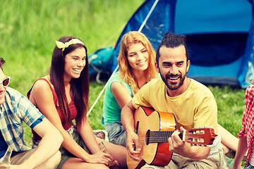 Image showing happy friends with drinks and guitar at camping