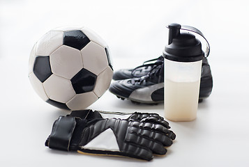 Image showing close up of football boots, gloves and bottle