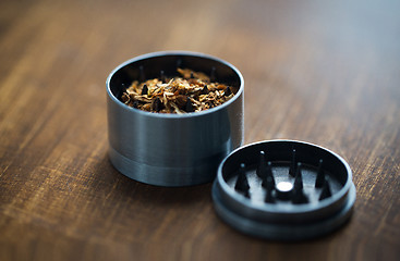 Image showing close up of marijuana or tobacco and herb grinder