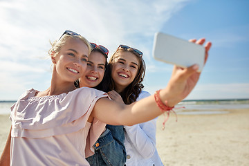 Image showing group of smiling women taking selfie on beach