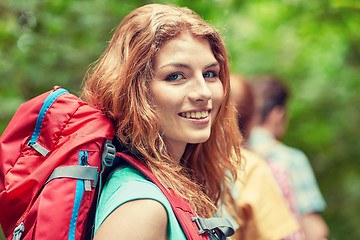 Image showing group of smiling friends with backpacks hiking