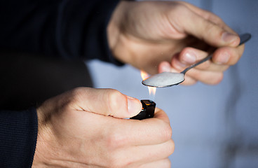 Image showing close up of addict preparing crack cocaine drug