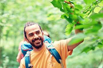 Image showing group of smiling friends with backpacks hiking