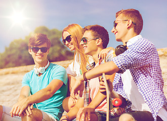 Image showing group of smiling friends sitting on city street