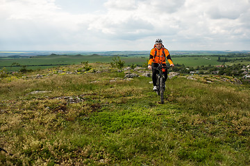 Image showing Young man is riding bicycle outside. Healthy Lifestyle.