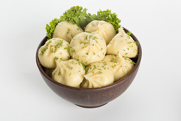 Image showing khinkali cooked on a ceramic plate