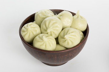 Image showing khinkali cooked on a ceramic plate