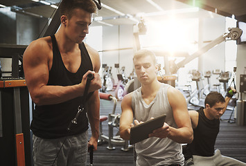 Image showing men exercising on gym machine