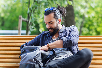 Image showing man with backpack and earphones in city