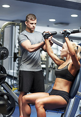 Image showing man and woman flexing muscles on gym machine