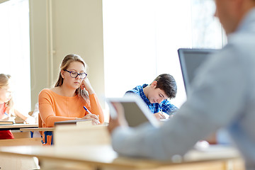 Image showing group of students with books writing school test