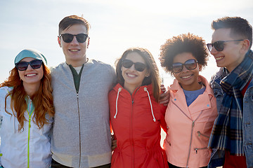 Image showing happy teenage friends in shades hugging on street