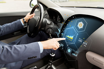 Image showing close up of man driving car with diagram on screen