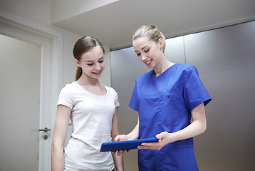 Image showing smiling nurse with tablet pc and girl at hospital