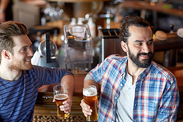 Image showing happy male friends drinking beer at bar or pub