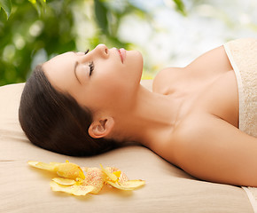 Image showing woman in spa lying on the massage desk