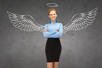 Image showing happy businesswoman with angel wings and nimbus