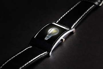 Image showing close up of smart watch with light bulb icon