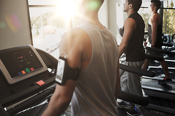 Image showing smiling men exercising on treadmill in gym