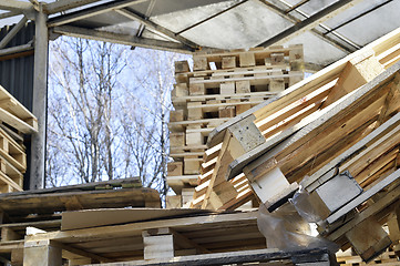 Image showing Waste wood from pallets stacked in the storage room