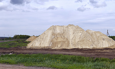 Image showing  Yellow excavator working digging in sand quarry