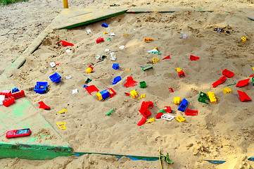 Image showing Children's sandbox with toys scattered