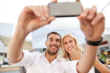 Image showing couple taking selfie with smatphone at restaurant