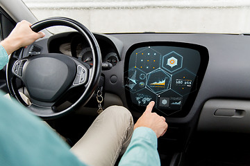 Image showing close up of man driving car with diagram on screen