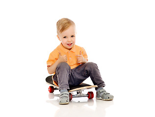 Image showing happy little boy on skateboard showing thumbs up