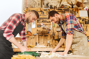 Image showing carpenters with blueprint at workshop