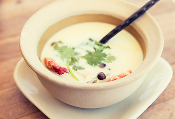 Image showing bowl of creamy soup with shrimps on table