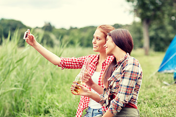 Image showing happy women taking selfie by smartphone at camping