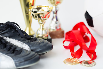 Image showing close up of football boots, cups and medals