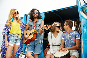 Image showing happy hippie friends playing music over minivan