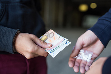 Image showing close up of addict buying dose from drug dealer