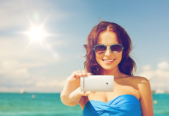 Image showing woman in bikini with phone