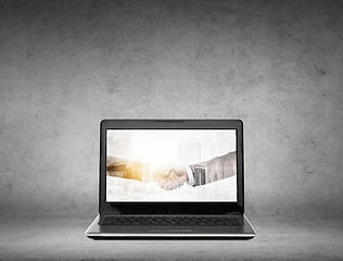 Image showing laptop computer with handshake on screen