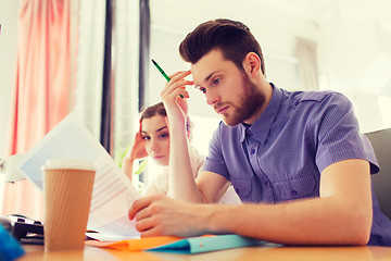 Image showing creative team with computer and papers in office