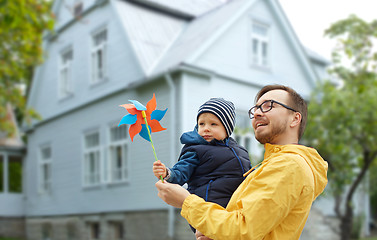 Image showing happy father and son with pinwheel toy outdoors